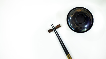 chopsticks and bowl on white background
