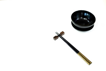 chopsticks and bowl on white background