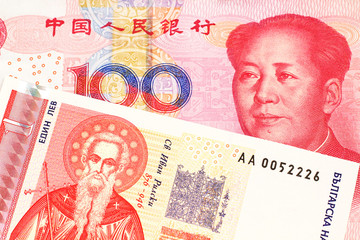 A Bulgarian one lev bank note with a red one hundred yuan renminbi Chinese bank note close up in macro