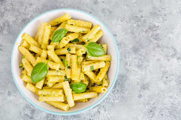 Italian pasta with pesto sauce and basil leaf
