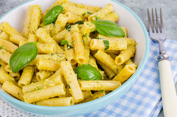 Italian pasta with pesto sauce and basil leaf