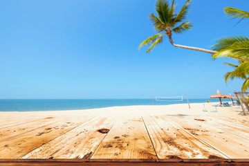 Top of wood table with seascape, palm tree, calm sea and sky at tropical beach background. Empty ready for your product display montage.  summer vacation background concept.