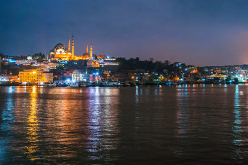 Fototapeta na wymiar Night view of Istanbul cityscape Suleymaniye Mosque (Rustem Pasha Mosque) with floating tourist boats in Bosphorus ,Istanbul Turkey