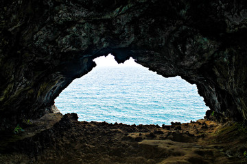 Rocky coastline with deep blue water on Easter Island, Chile, showcasing the island's natural beauty and stunning Pacific Ocean views - Cueva de Los dos Ventanas