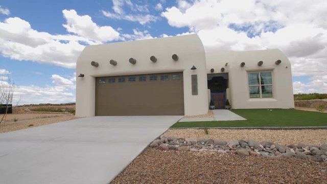 Southwest Home White Exterior Lower Daytime. view moves down on a traditional new southwest style adobe home in New Mexico