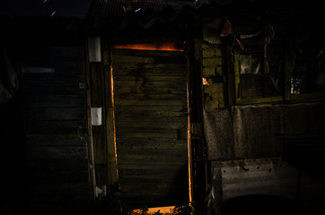 Fototapeta na wymiar Close up view of old antique wooden door inside a dark room. Selective focus.