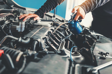 Fototapeta premium Technician Hands of car mechanic working in auto repair Service and Maintenance car