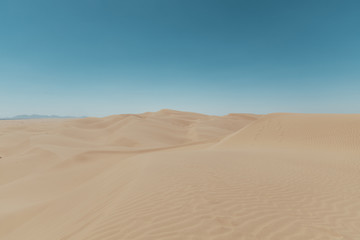 Fototapeta na wymiar sand dunes with blue sky