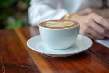 Coffee latte on wood table in coffee shop