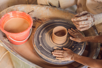 Fototapeta na wymiar Father and son doing ceramic pot in pottery workshop