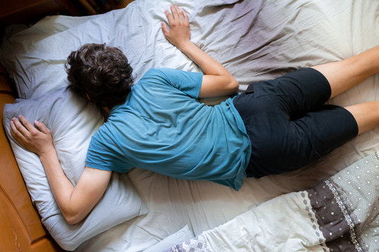 person's wrong position during the sleep in bed, bad posture
