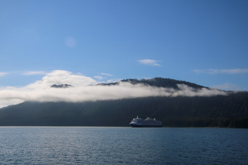 lake and mountains with a cruise ship in the background in Alaska