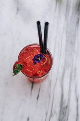 Fototapeta na wymiar Red, fresh summer strawberry cocktail juice beverage with ice.