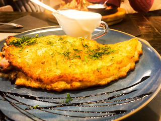 Potato pancake with mushrooms in pan