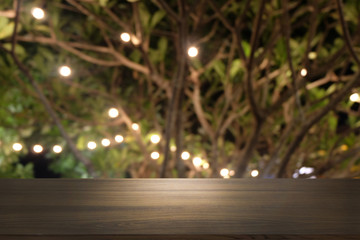 Empty dark wooden table in front of abstract blurred bokeh background of restaurant . can be used for display or montage your products.Mock up for space.