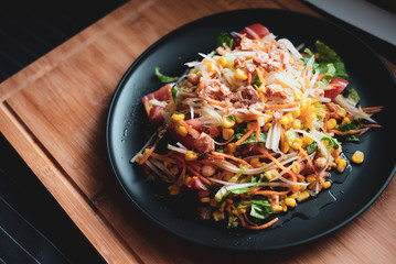 thai asian food papaya salad. top view on wooden background.  healthy diet meal