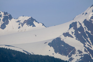 Fototapeta na wymiar Helicopter Flying into a Glacier