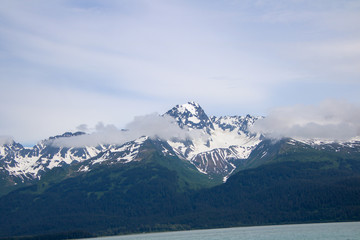 Fototapeta na wymiar Snow capped mountains in the rugged Alaska Landscape