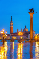 Naklejka premium Piazza San Marco at night, view on venetian lion and san giorgio maggiore, Vinice, Italy