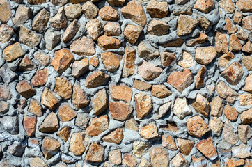 old granite wall of stone fragments