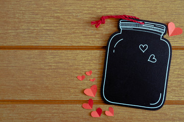 Black wooden tag with red hearts on the wooden background