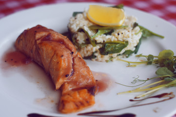 Restaurant feed. Salmon with risotto. Fish and rice Fish with lemon. Dish in the restaurant. National food.