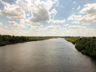 View of the river and the blue sky with clouds from the railway bridge.