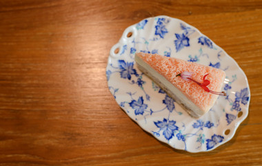 Top view of Piece of homemade taro cake in classic plate on table with copy space for text