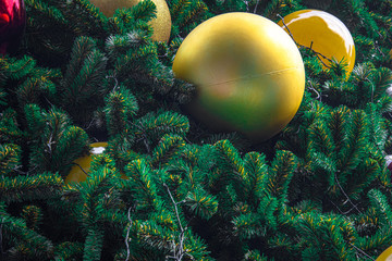 Obraz na płótnie Canvas Decoration of Christmas tree with hanging golden yellow ball.