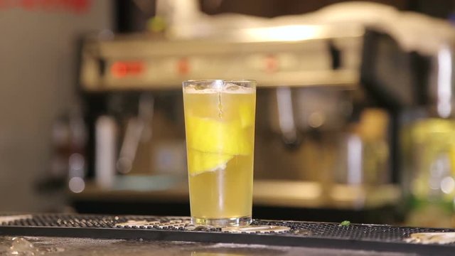 Fresh cocktail with orange, limet, mint and ice. Alcoholic, non-alcoholic drink-beverage at the bar counter in the night club.