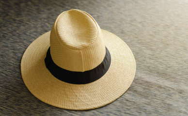 straw hat with black ribbon on sofa wtih free space, vacation travel in summer concept