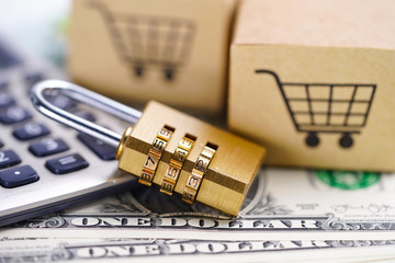 Golden secutiry digital password lock key and Box with shopping cart logo on us dollar banknotes : Import Export online or eCommerce delivery service store product shipping, trade, supplier concept.