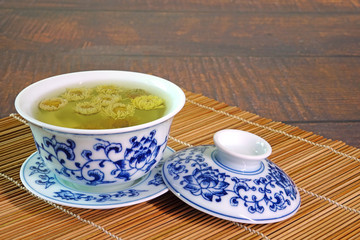 Chrysanthemum tea. Chinese tradition chrysanthemum tea in beautiful blue and white porcelain cup, famous herbal tea from Huangshan , Anhui China. Selective focus, copy space.