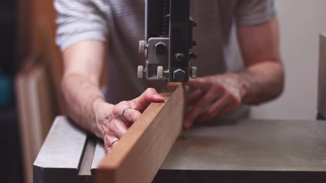 Carpenter cut wooden piece for guitar making purpouse