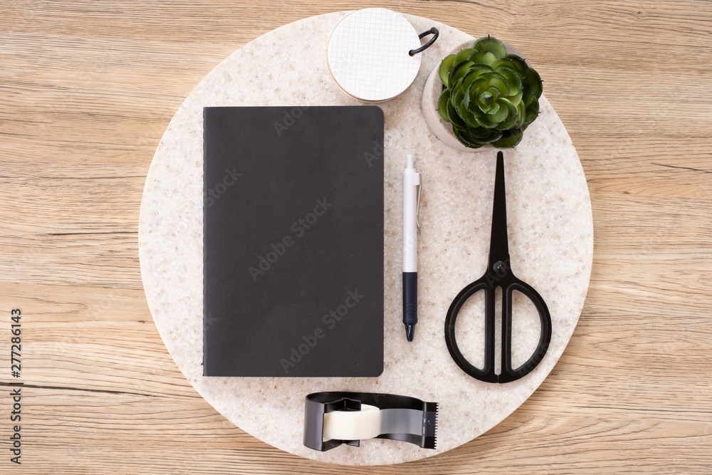 Aufkleber top view black notebook with office stationery on wooden table with copy space.student stuff on desk.education concept.