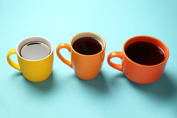 Black tea (coffee) in bright cups, office break, team building.