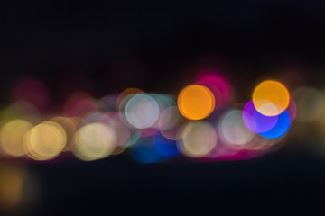 Colored unfocused lights on black background