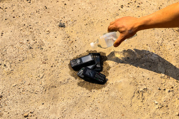 burnt mobile phones on textural concrete background. Concept: Danger of using low-quality cell phones.