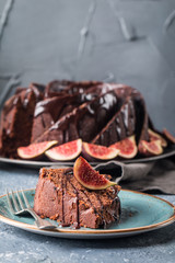 Gingerbread Bundt Cake for Christmas with figs and lingonberry over gray background