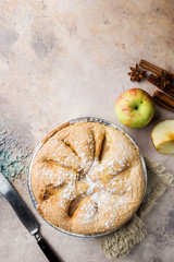 Apple pies and ingredients over stone background. Top view.