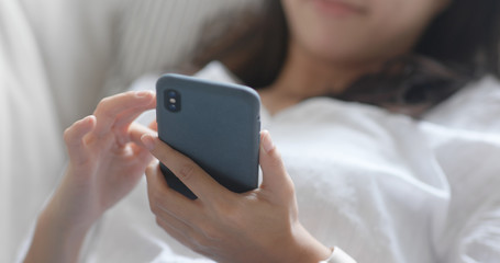 Woman use of mobile phone online at home