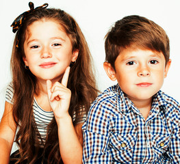 little cute boy and girl hugging playing on white background, happy smiling family, lifestyle people concept close up