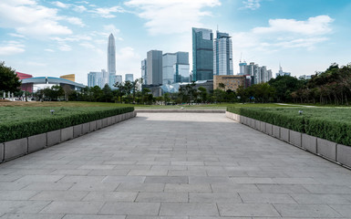 Empty square tiles and skyline of urban Architecture