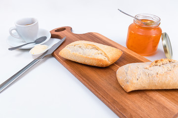 Wooden board with tasty breakfast toasts on white background
