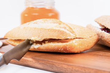 selective focus, a knife, bread and orange marmalade.