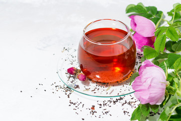 fragrant tea with wild rose in a glass cup, closeup