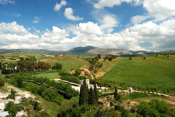 Fototapeta na wymiar Elevated view across farmland and the countryside towards the mountains, Ronda, Spain.
