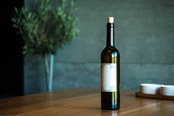 Fototapeta premium Pouring red wine on a wooden oak table