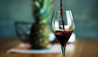 Pouring red wine on a wooden oak table