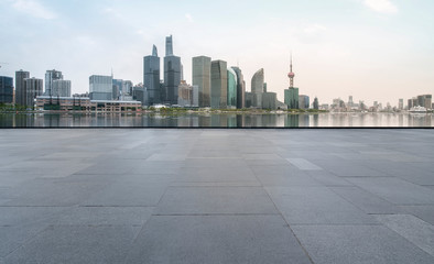 Obraz premium Urban skyscrapers with empty square floor tiles